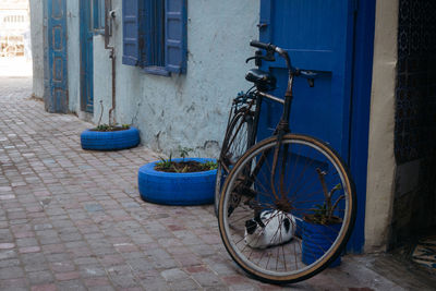 Bicycle parked on sidewalk by building