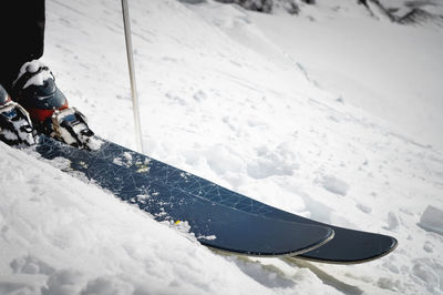 Close-up of boots and ski on a snow-covered mountain slope. extreme sport. winter sports concept