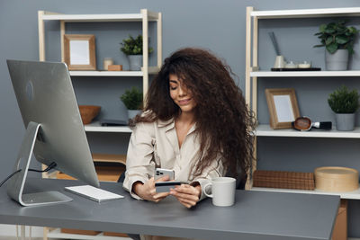 Young woman using laptop at table