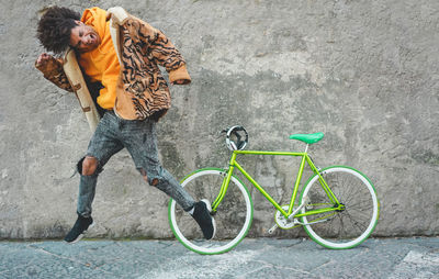 Full length of woman with bicycle