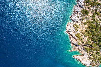 High angle view of rocks on sea shore