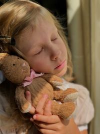 Close-up portrait of a girl with toy