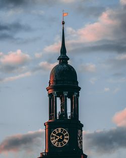 Low angle view of clock tower against sky during sunset