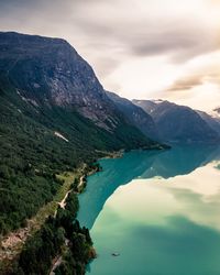 Scenic view of lake and mountains against sky