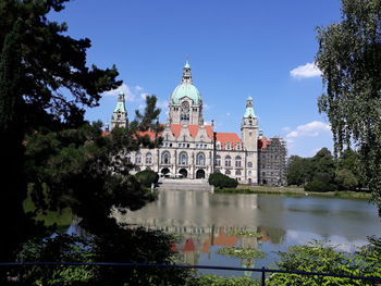 View of building against sky with lake in foreground