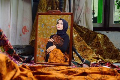 Portrait of woman sitting in temple