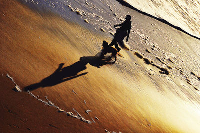 High angle view of person shadow on sand