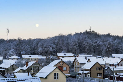 Buildings in city against clear sky