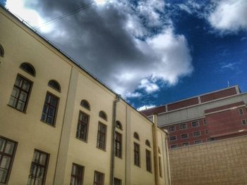 Low angle view of building against cloudy sky