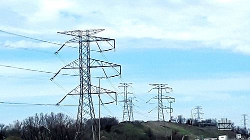 Low angle view of electricity pylon against sky