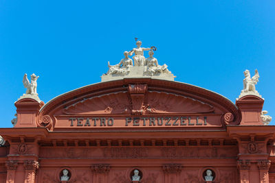 Low angle view of statue against blue sky