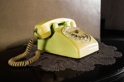 Close-up of telephone on table