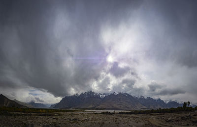 Scenic view of mountains against cloudy sky
