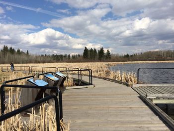 Pier over lake against sky