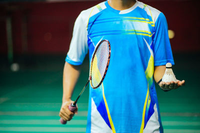 Midsection of man playing with umbrella