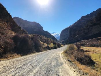 Road amidst mountains against sky