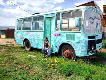 Side view of abandoned vehicle on field