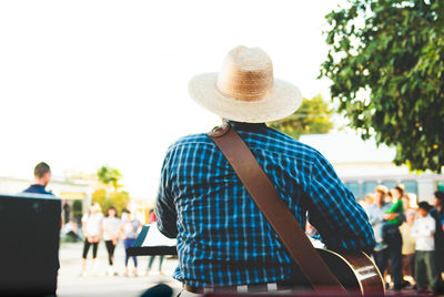 Men in hat against sky