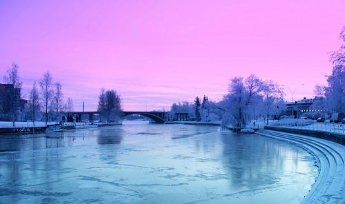 Scenic view of frozen river against sky during winter