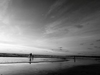 Man on beach against sky