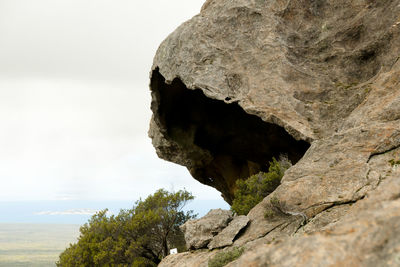 Low angle view of rock formation against sky