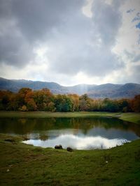 Scenic view of lake against cloudy sky