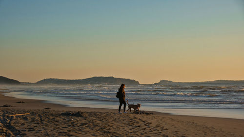 Scenic view of beach against sky during sunset