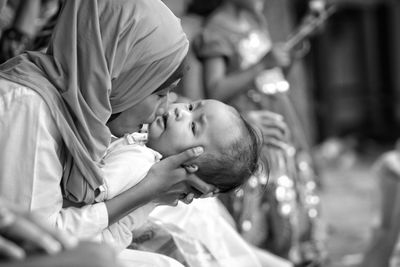 Mother kissing baby girl