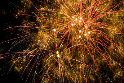 Low angle view of firework display at night