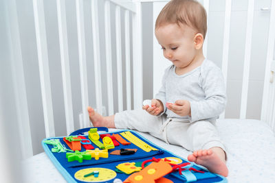 Boy playing with toy blocks at home