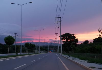 Street against sky at sunset