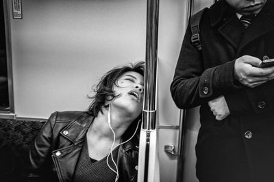 Portrait of young woman standing at train