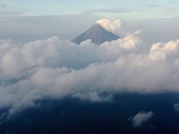 Aerial view of snowcapped mountain against cloudy sky