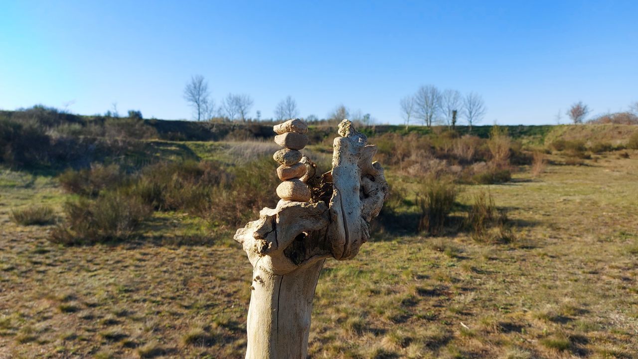 CROSS ON LAND AGAINST SKY