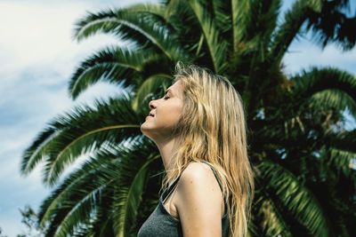 Low section of woman with palm tree