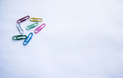 High angle view of colored pencils over white background