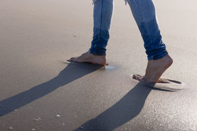 Man walking barefoot on the beach