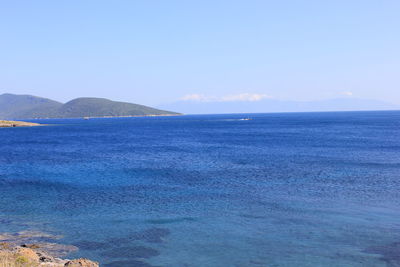 Scenic view of sea against blue sky