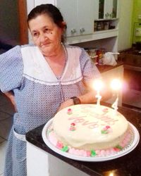 Mid section of woman with chocolate cake