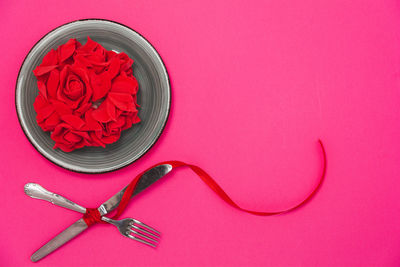 High angle view of pink rose on table