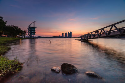 Bridge over river at sunset