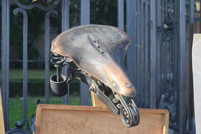 Close-up of antique bicycle saddle on wood at berlin flea market