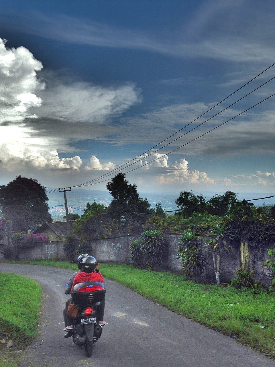 transportation, sky, cloud - sky, land vehicle, mode of transport, road, tree, cloudy, car, power line, nature, cloud, electricity pylon, on the move, full length, grass, street, lifestyles