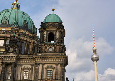 Low angle view of cathedral by fernsehturm against sky