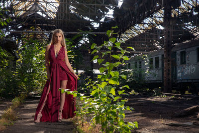 Portrait of beautiful woman standing at abandoned railroad station