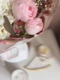 High angle view of pink rose on table
