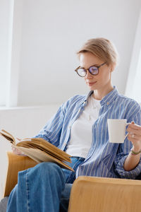 Mid adult man holding coffee cup