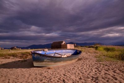 Boats in sea against cloudy sky