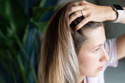 Close-up of woman with hand in hair