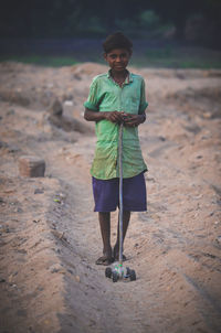 Portrait of happy boy standing on land